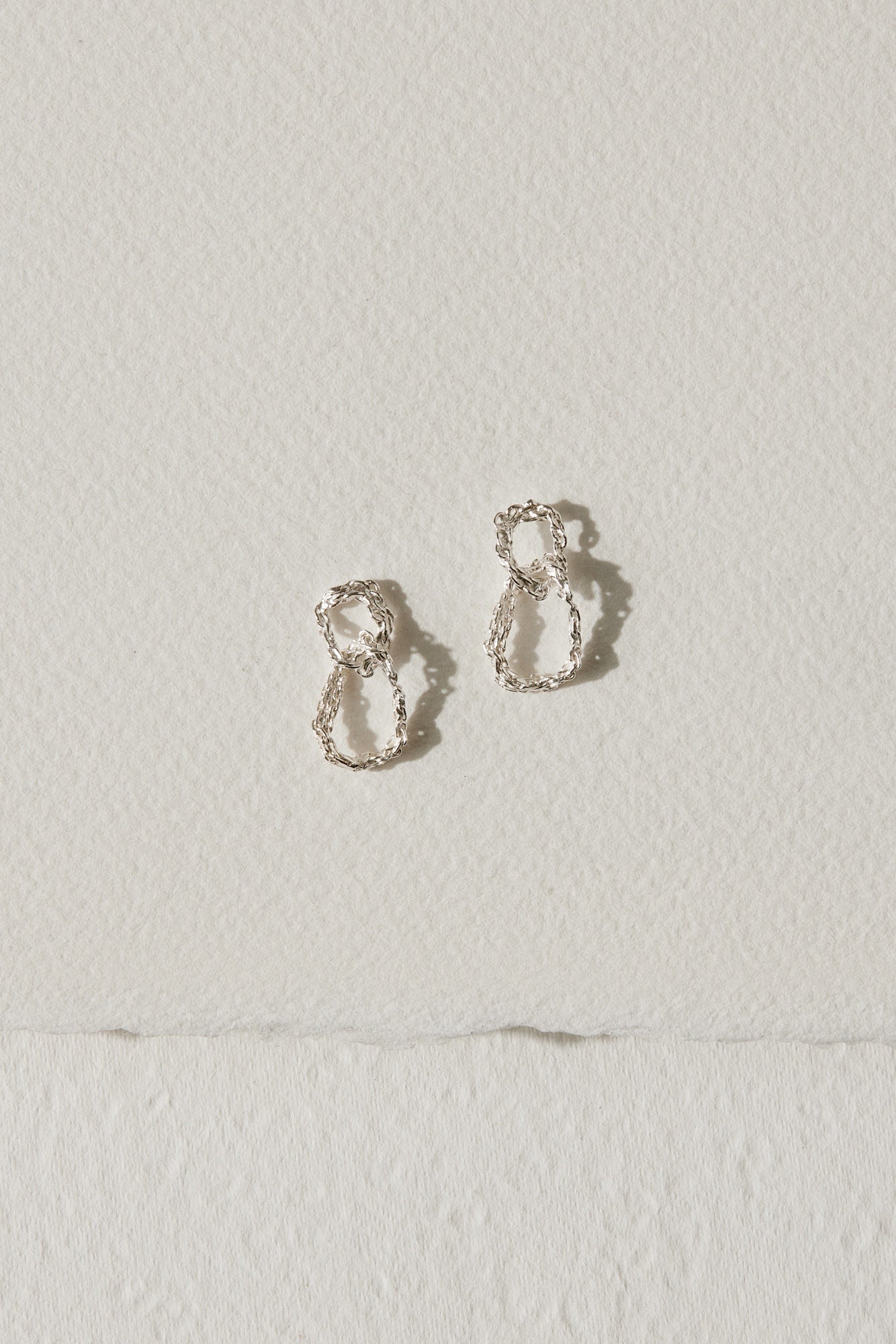 Silver drop earrings with two interlocking circles by Camillette Jewelry